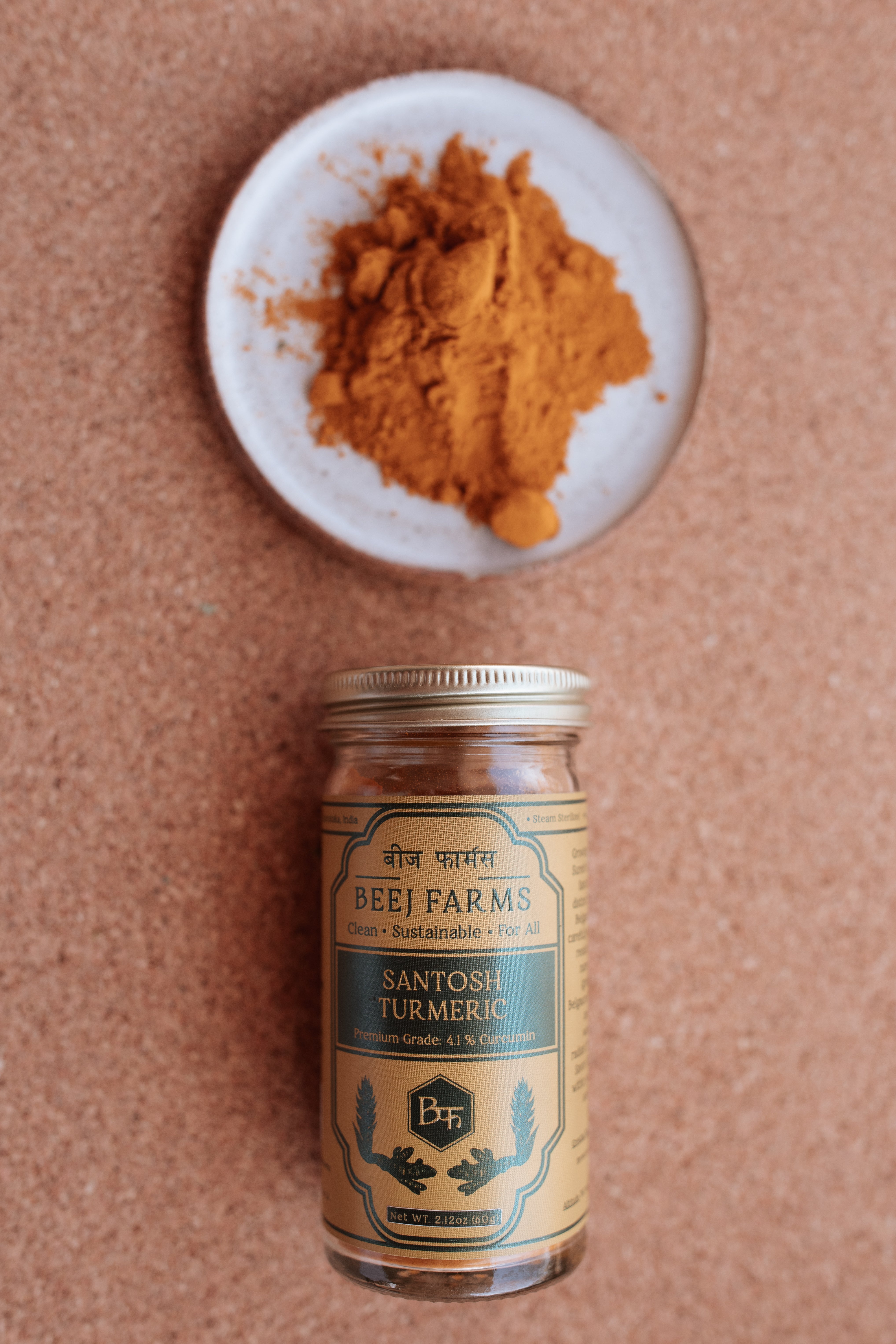 Vibrant golden turmeric from Beej Farms displayed on a ceramic dish with a neutral background
